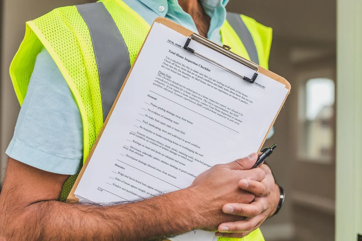 Técnico segurando prancheta com checklist de inspeção e caneta